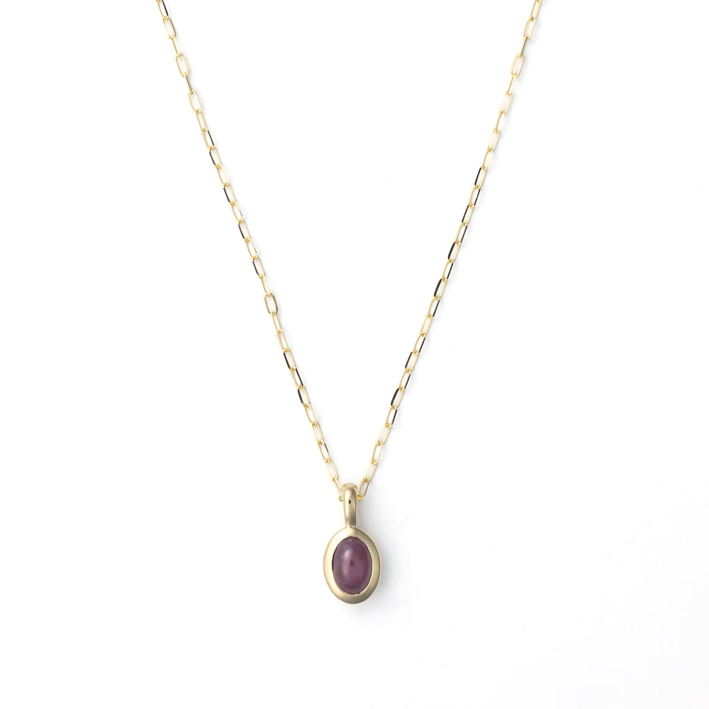 Ruby pendant on gold paperclip chain.