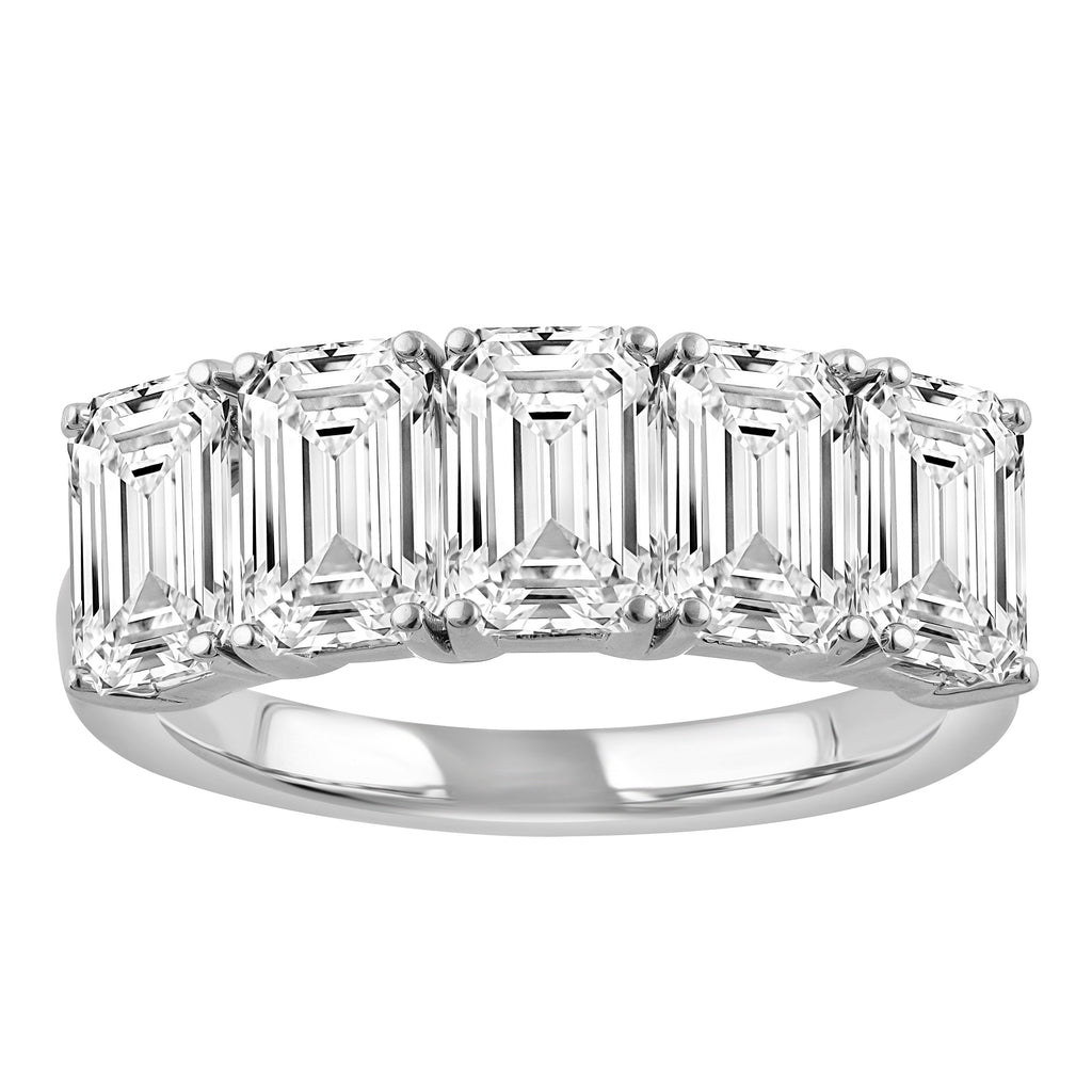 Five emerald-cut diamonds on white gold band.