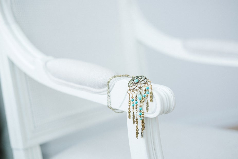 Turquoise dreamcatcher necklace with silver feathers.