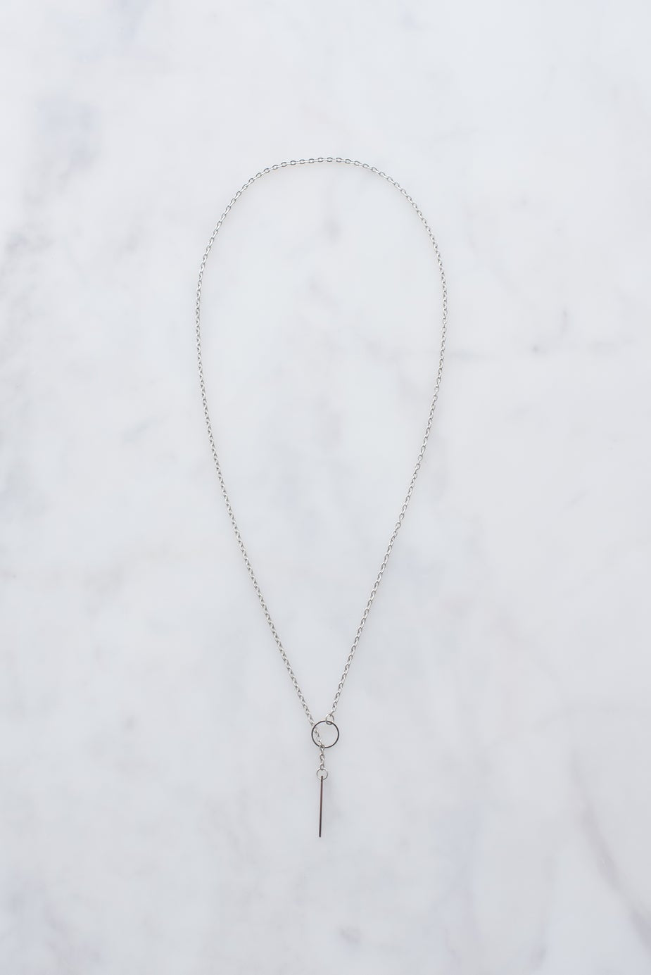 Sterling silver necklace with circular pendant.
