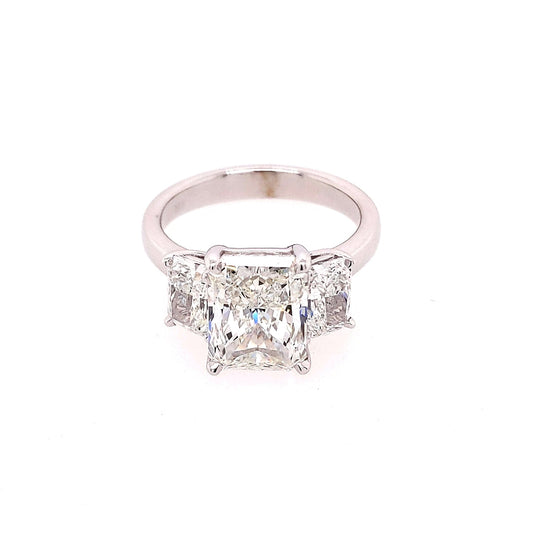 Three-stone radiant diamond ring in white gold.