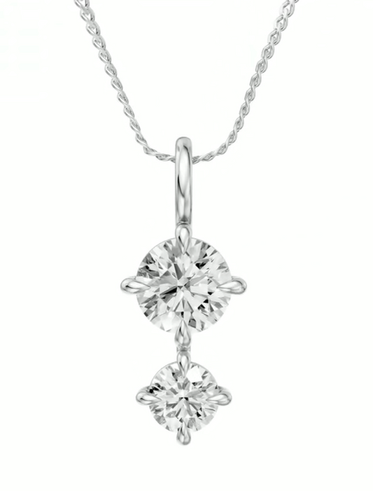 Two round diamonds on gold pendant.