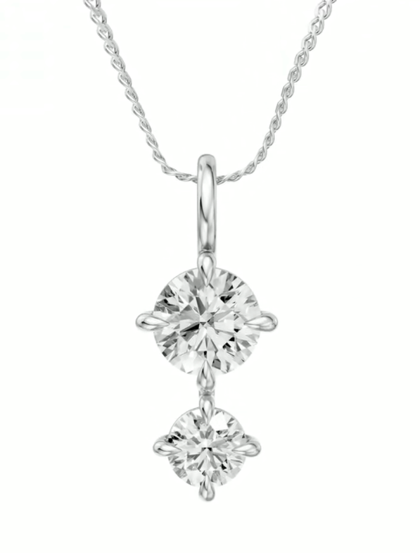 Two round diamonds on yellow gold pendant.