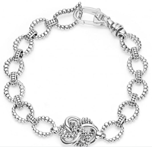 Sterling silver oval link bracelet, intricate design.
