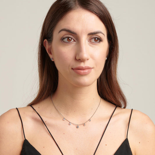 Simulated diamond pendant necklace on model.
