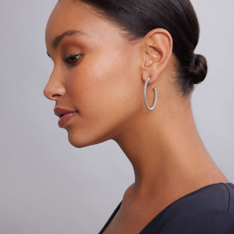 Sterling silver large hoop earrings worn.