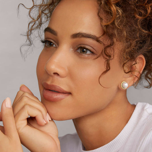 Yellow pearl stud earrings in silver.