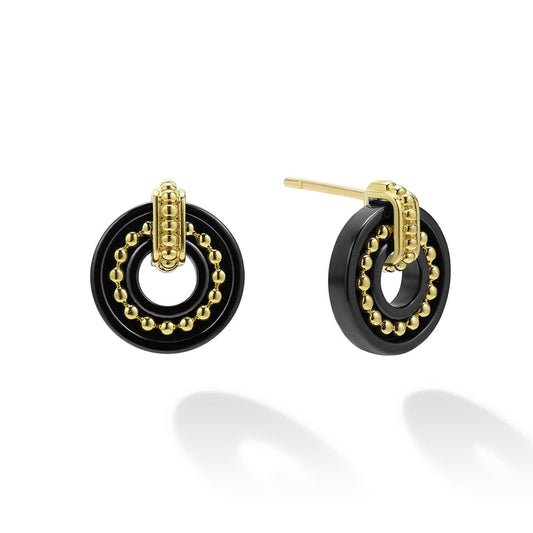 Black and yellow gold circular stud earrings.