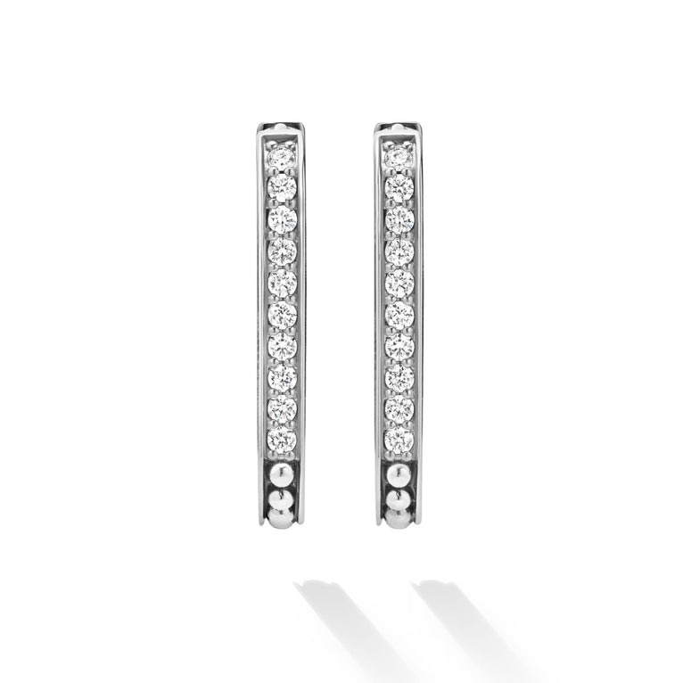 Diamond-studded silver hoop earrings.