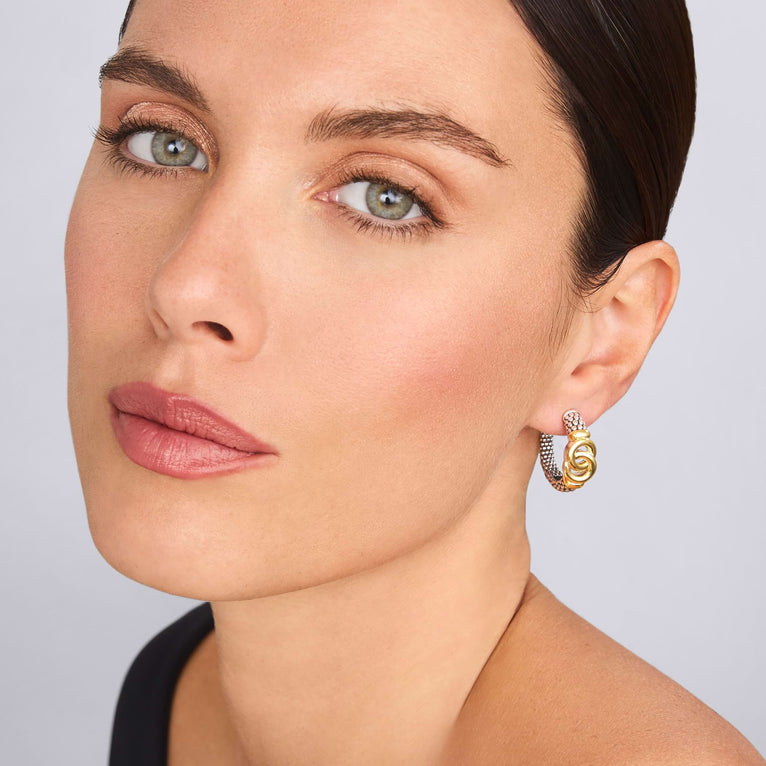 Sterling silver and gold medium hoop earrings.