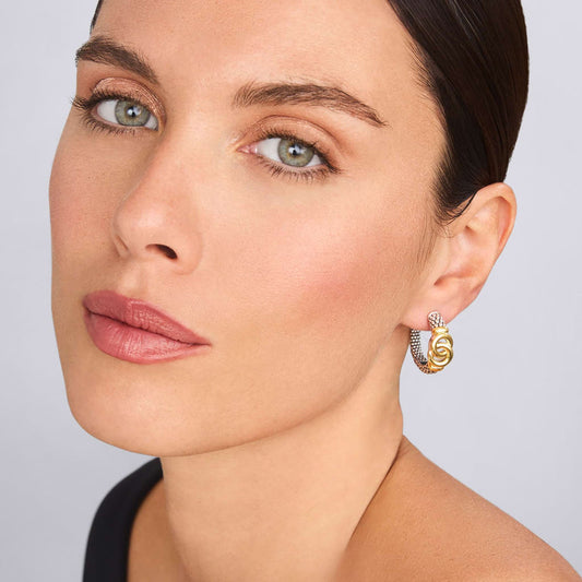 Sterling silver and gold medium hoop earrings.
