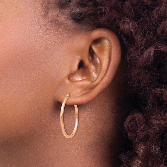 14K rose gold polished hoop earrings.