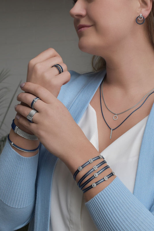 Blue stainless steel cable ring with diamond.
