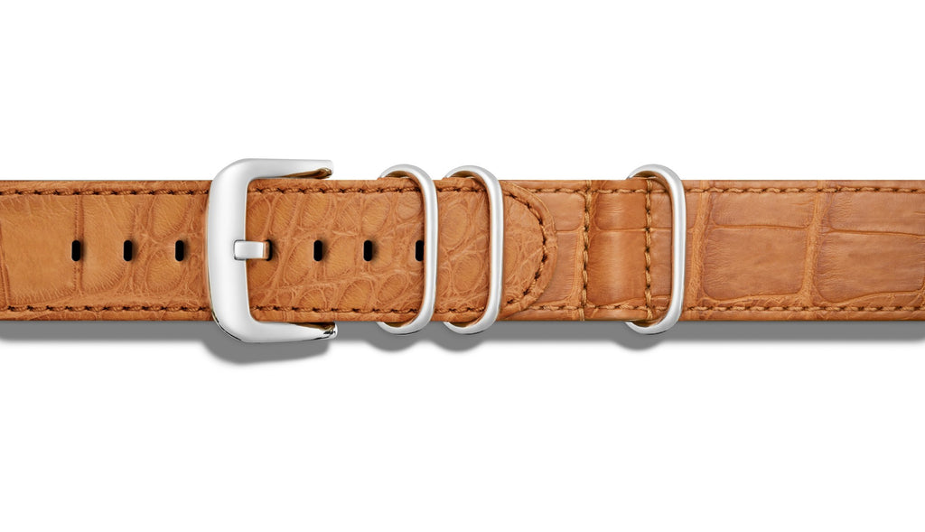 Tan alligator leather watch band with buckle.