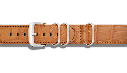 Tan alligator leather watch band with buckle.