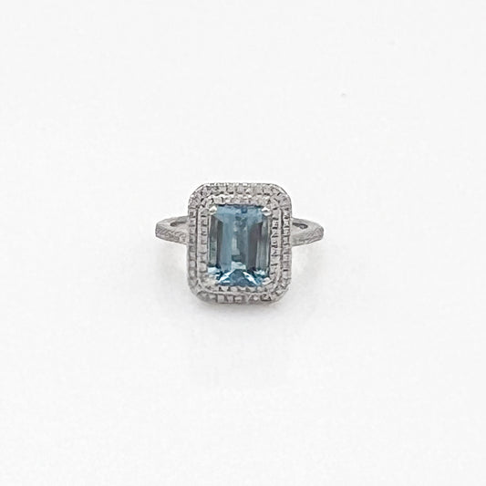 Emerald-cut aquamarine ring with diamond halo.
