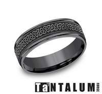 Tantalum grey carved band with intricate design.