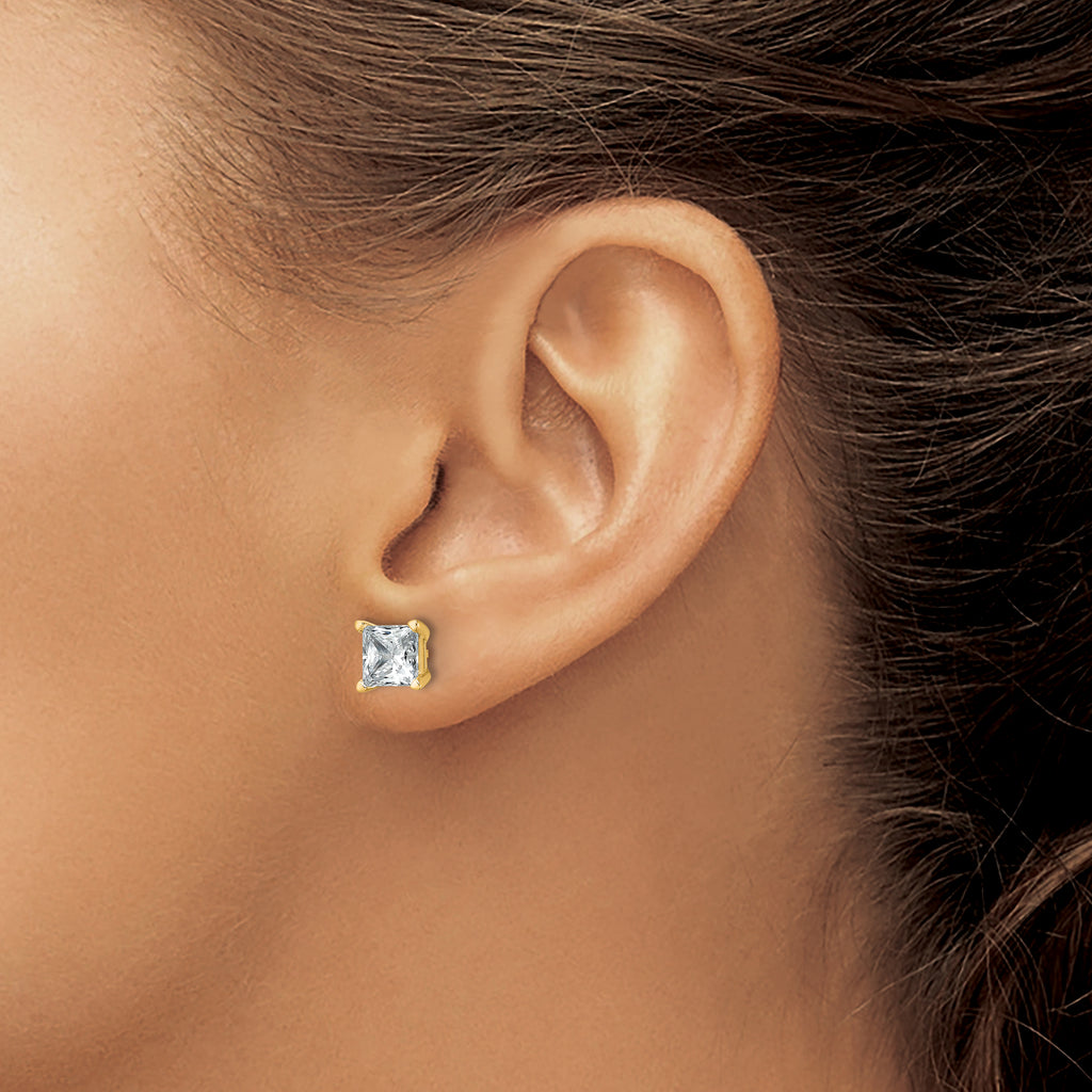 Princess-cut diamond studs in yellow gold.