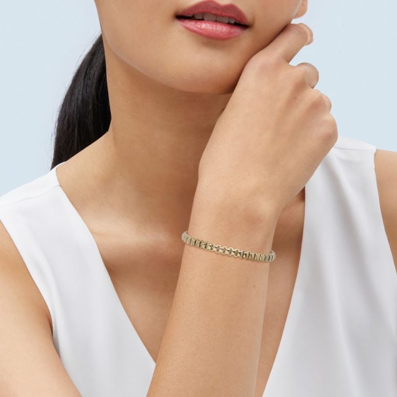 14K yellow gold flexible bracelet on wrist.