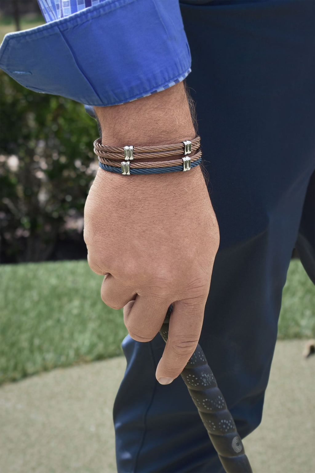 Brown stainless steel bangle bracelet on wrist.