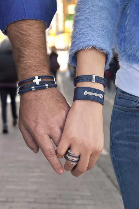 Blue diamond-accented bracelets on wrists.