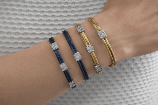 Yellow and blue cable bracelets with diamonds.