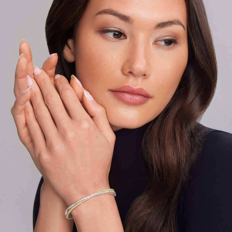 Sterling silver diamond bracelet with gold accents.