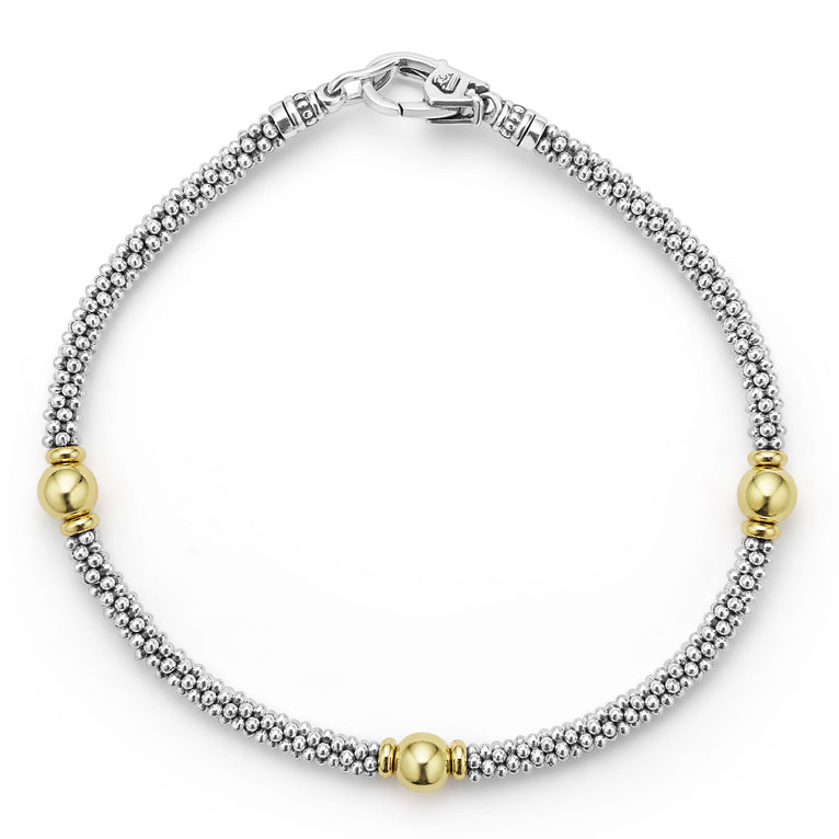Sterling silver bracelet with gold beads.