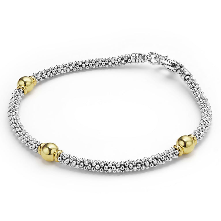 Sterling silver bracelet with gold beads.