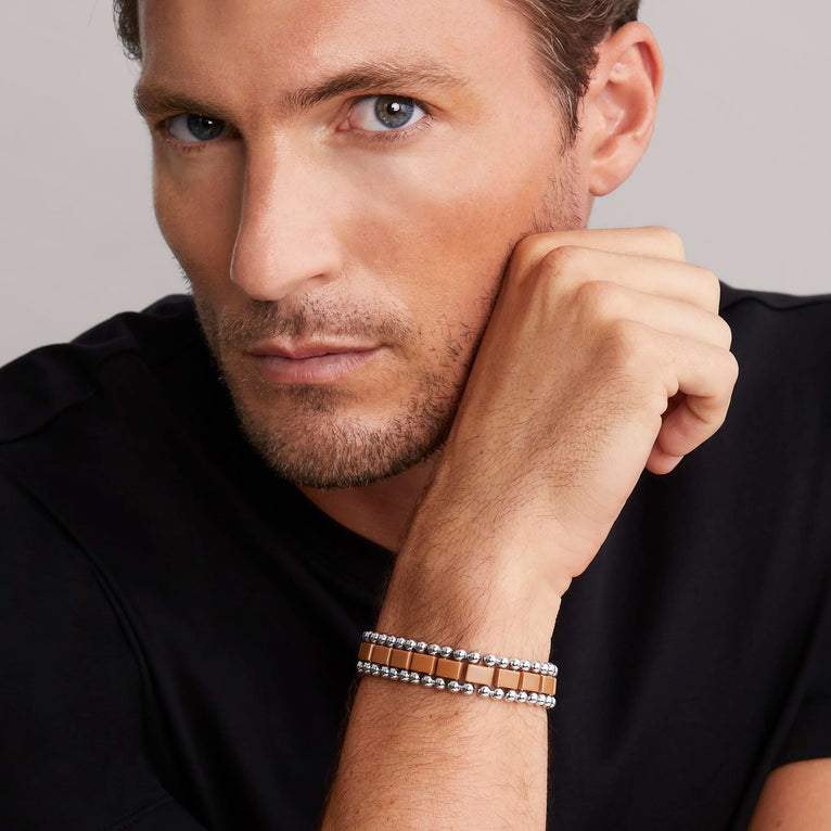 Brown ceramic fancy link bracelet on wrist.