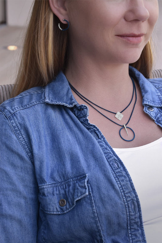 Blue diamond necklace with rose gold accents.