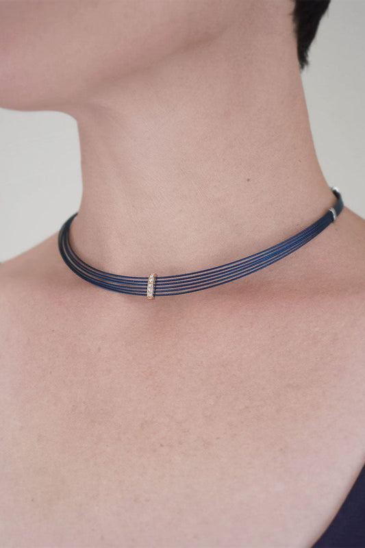 Blue cable necklace with diamond accent.