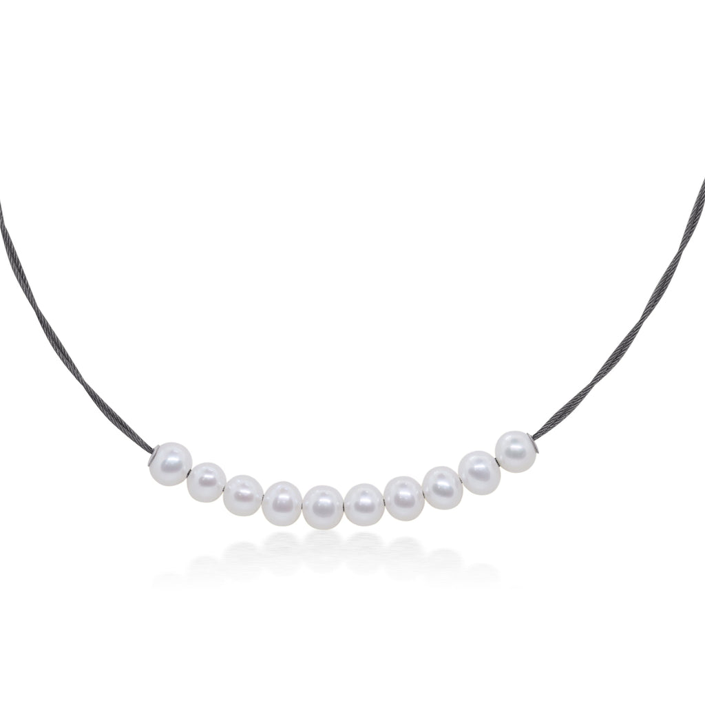 Pearl choker on black stainless steel cord.