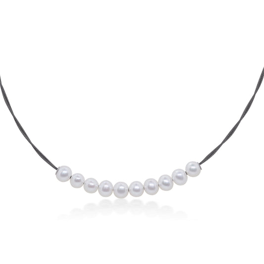 Pearl choker on black stainless steel cord.