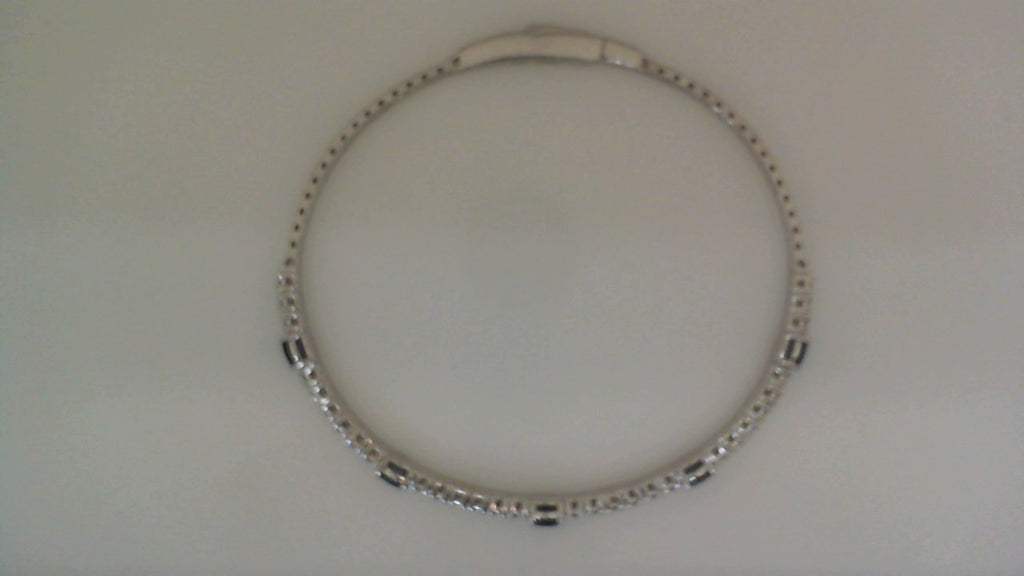 14K white gold bangle with sapphires.