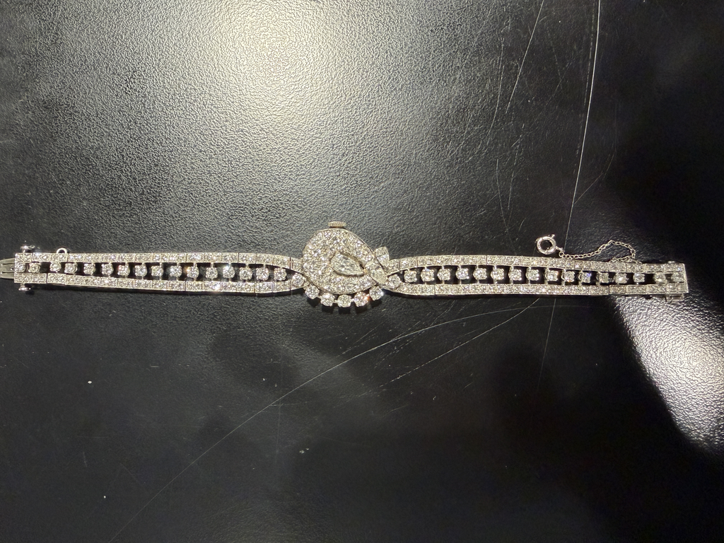 Platinum ladies watch with diamond accents.