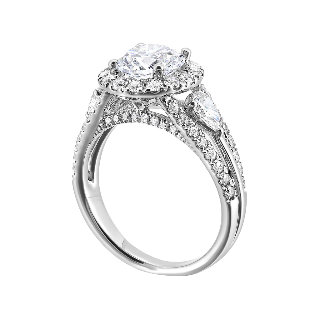Halo three-stone diamond ring in white gold.