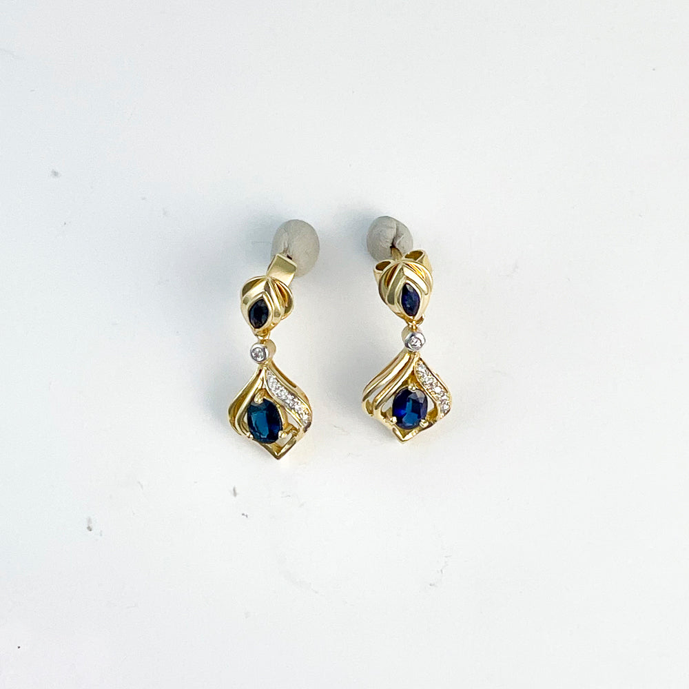 18K gold earrings with blue sapphires.
