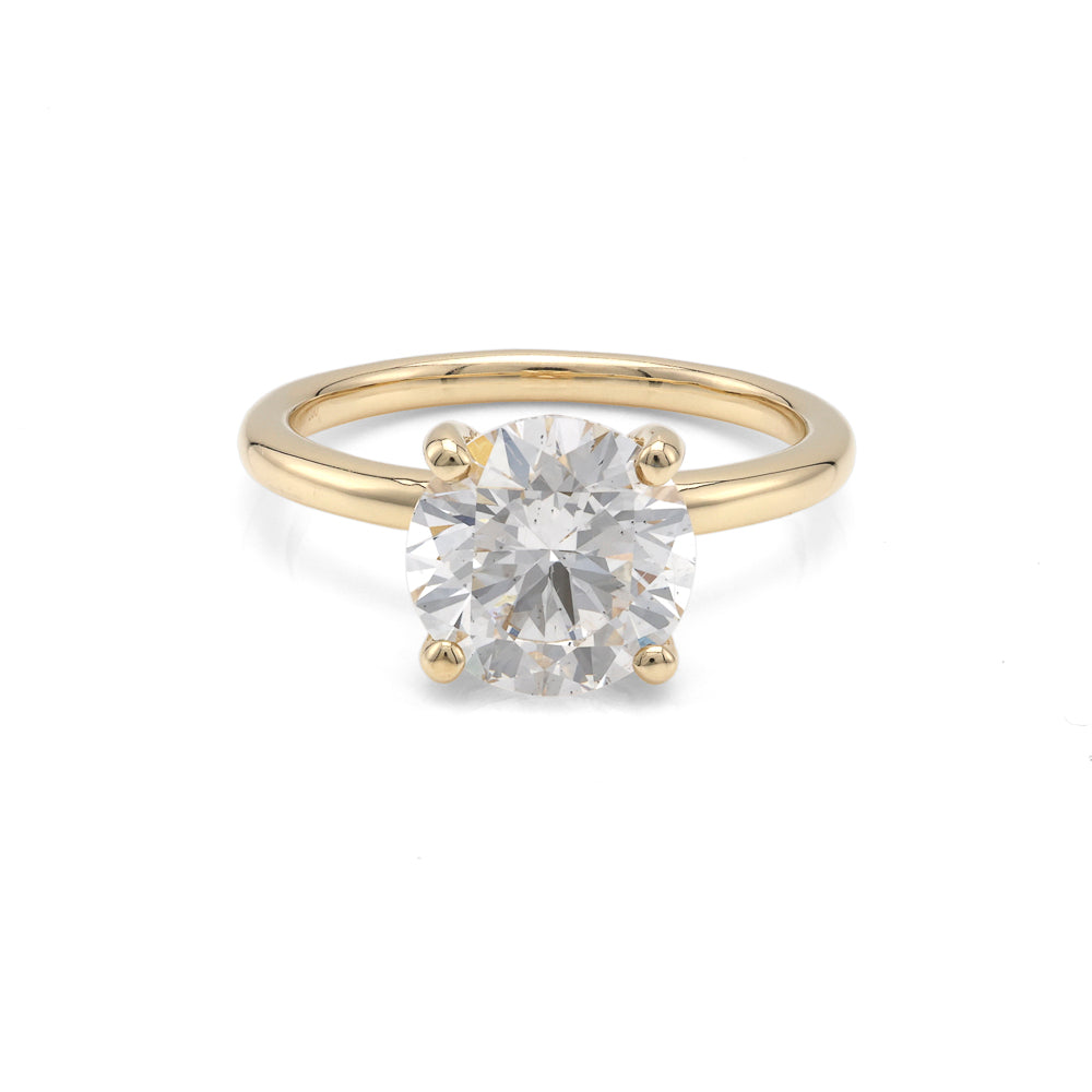 Yellow gold ring with round diamond centerpiece.
