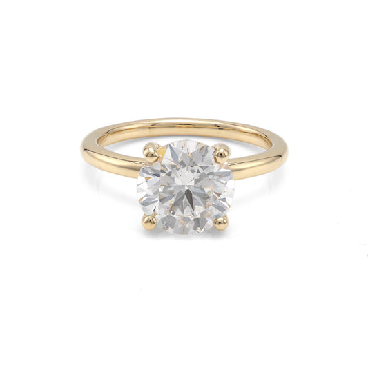 Yellow gold ring with round diamond centerpiece.