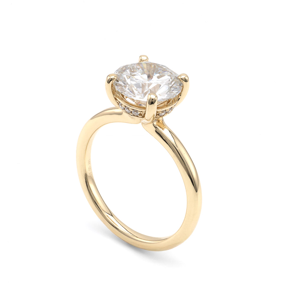 Yellow gold solitaire ring with round diamond.