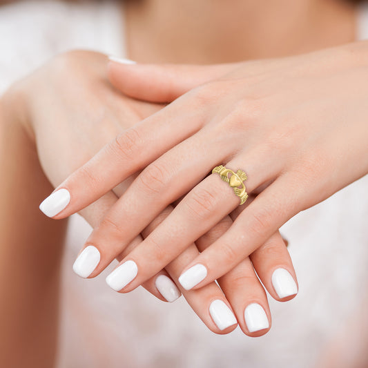 Yellow gold Claddagh ring on hand.