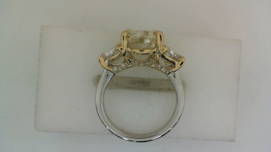 Three-stone ring with yellow diamond accents.