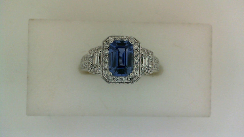 Emerald-cut sapphire ring with diamond accents.