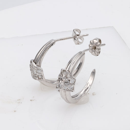 14K white gold diamond J hoop earrings.