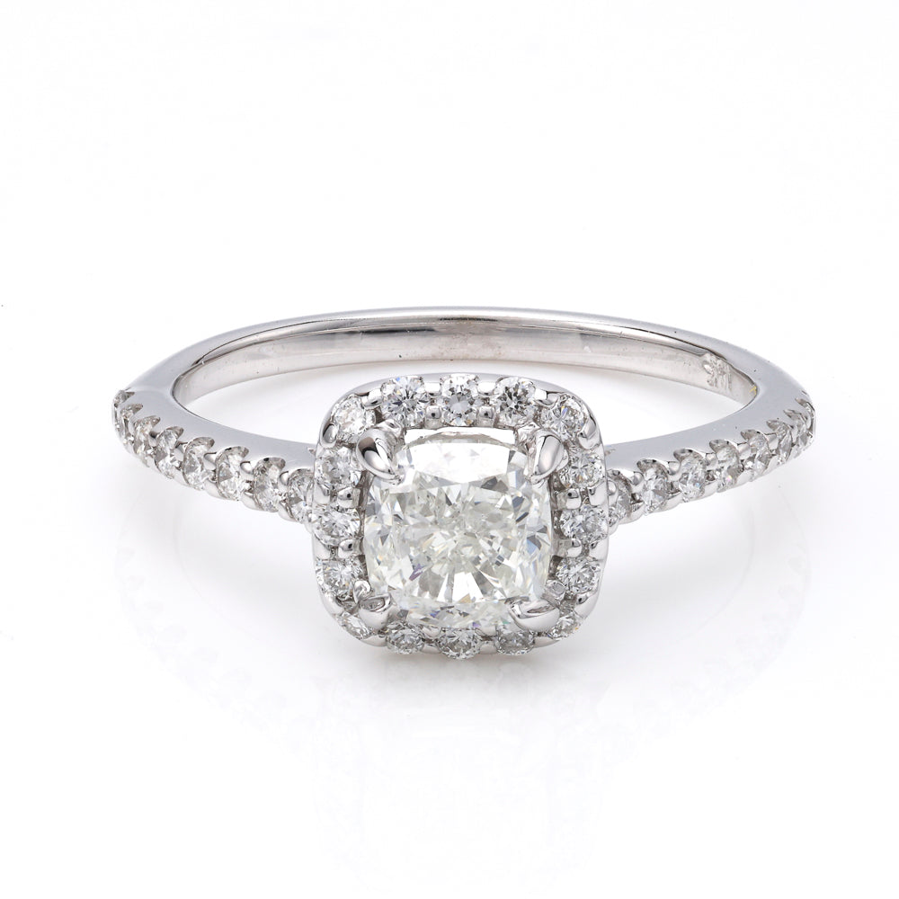 Cushion diamond halo engagement ring in white gold.