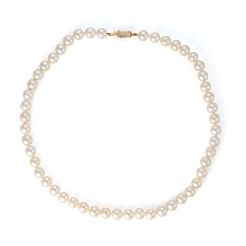 Cream pearl strand necklace with gold clasp.
