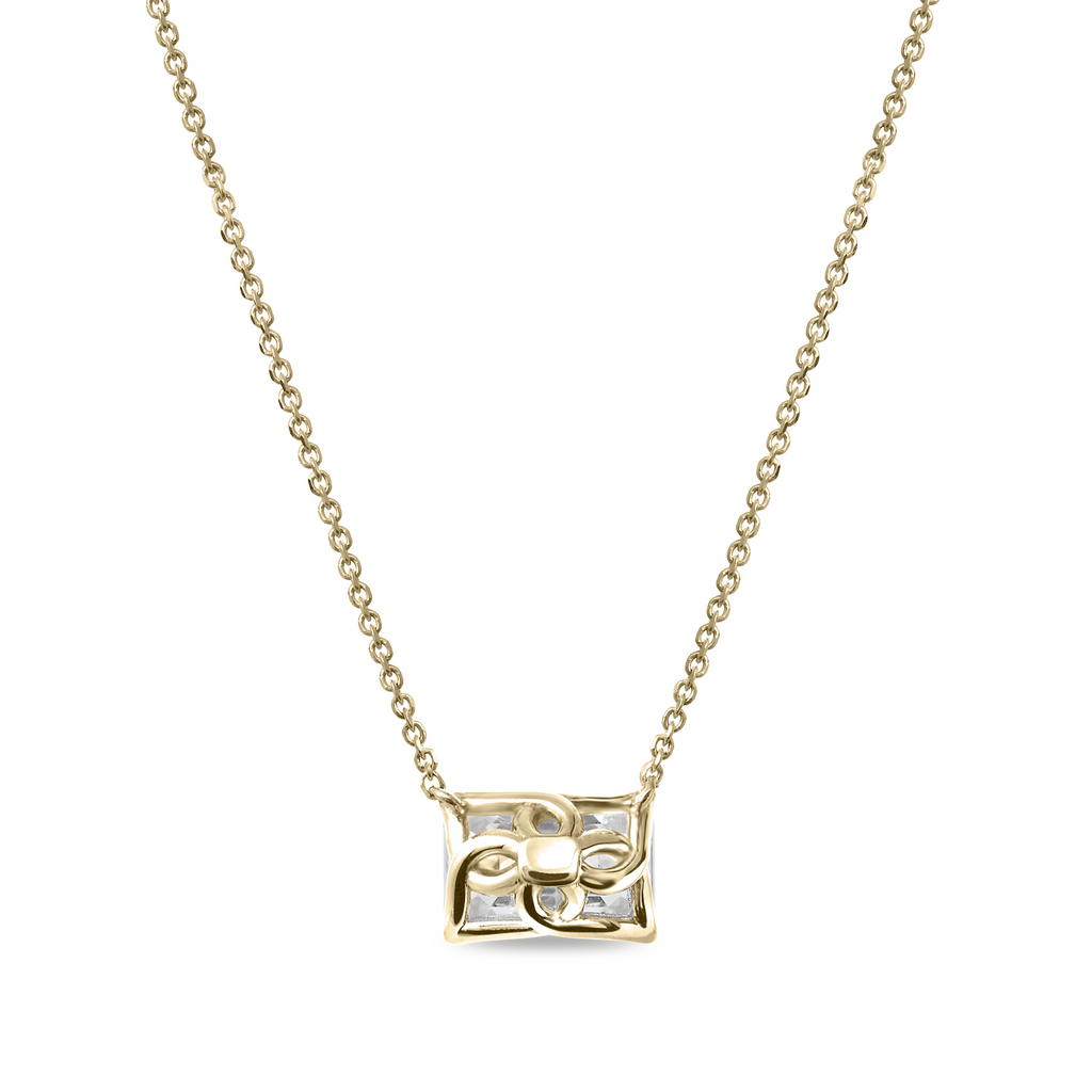 Emerald-cut diamond pendant on gold chain.