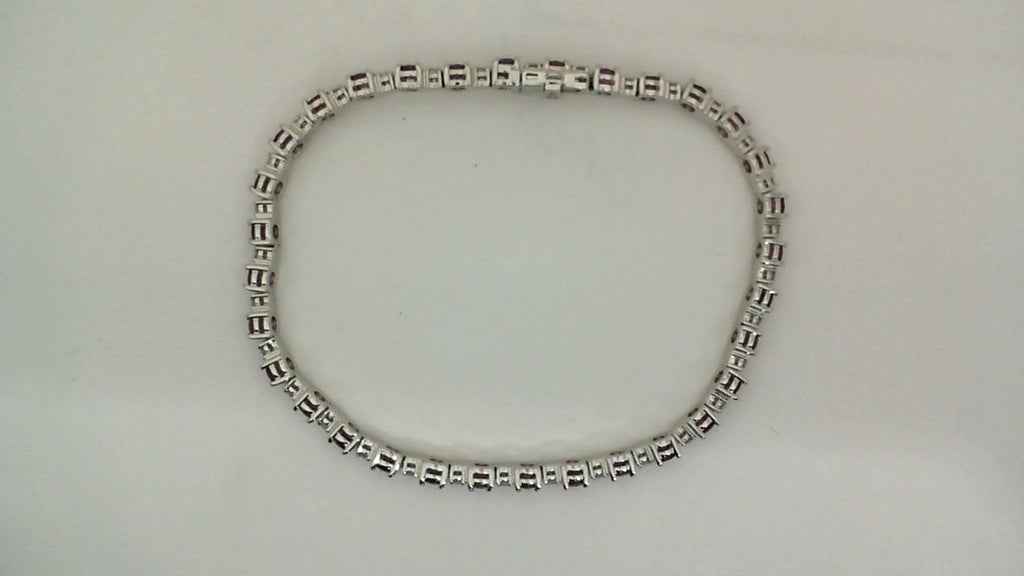 14K white bracelet with round rubies.
