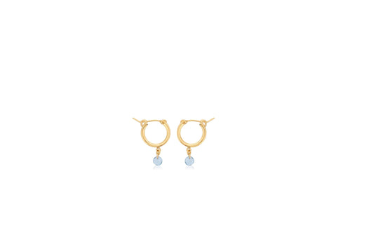 Gold hoops with dangling blue topazes.